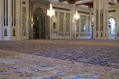 Muscat 04 Grand Mosque 06 Large Persian Carpet The main prayer hall has the largest carpet in the world, a 70m x 60m Persian carpet that took 600 women four years to weave. On the back wall is the mihrab, a niche in the wall facing Mecca. To the right of the mihrab is the minbar, a pulpit chair dating from the Prophet Mohammeds time. The `imam', the one who leads the prayer, delivers the `khutba', the Friday sermon, which can deal with religious, social and political subjects.